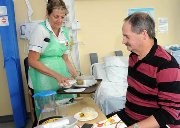Bob Chaytor from Forest Town is served his mid-day meal by healthcare assistant Lesley Ritchie.