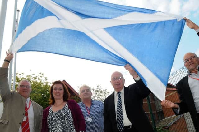In support of the Union!  Ashfield District Council councillors, from left, Chris Baron,Cheryl Butler, Jim Aspinall, John Wilmott, and Linford Gibbons prepare to raise Scottish Saltire at the council offices in Kirkby on Monday.