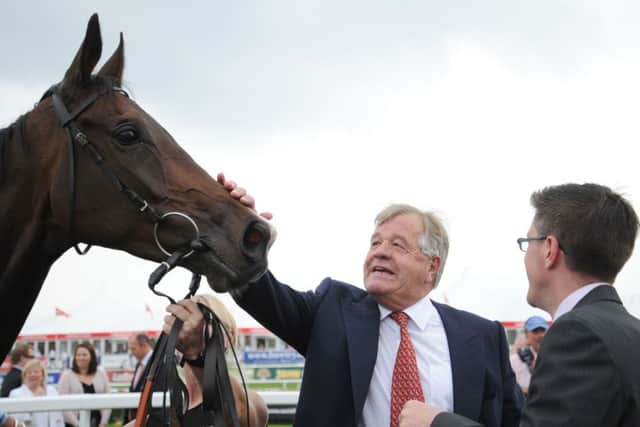 SIR MICHAEL STOUTE (centre), who trains today's Tip Of The Day (PHOTO BY: Anna Gowthorpe/PA Wire).