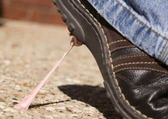 Chewing gum on a pavement stuck to a shoe