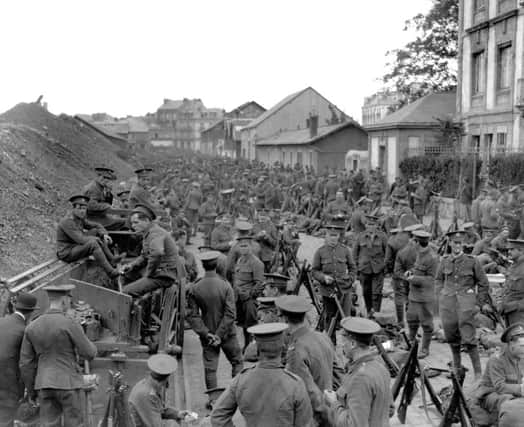 1914: British soldiers from the Royal Welch Fusiliers and the Cheshire Regiment in a Belgian town on their way to Mons as part of the British Expeditionary Force. Both 1st and 2nd Bns of the RWF were part of the BEF. Their ranks later included the poets Siegfried Sassoon and Robert Graves.  Picture part of PA First World War collection.