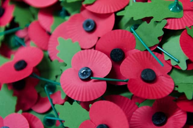 A pile of the iconic red emblem of the British Legion's annual poppy appeal sits on a work bench at the company headquarters in Richmond, London.