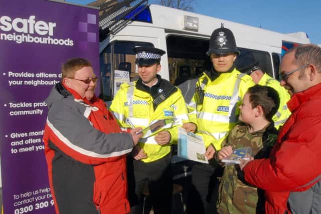 Community Police Day in Hucknall. PCSO Simon Gazzard and PC Simon Lacey hand over a Smartwater set to the Werle family.