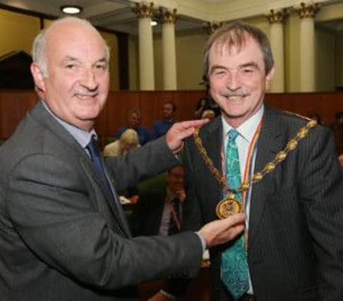 Councillor Steve Freeborn, pictured right, receives the chain of office from John McElvaney, director of legal services.