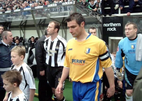 06-0025-13

Stags captain walks out at St James park side by side with Shearer