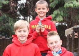 Mansfield junior triathletes celebrate their achievements. Back, from left: Jack Mottram, Kieran Smith, and Matthew Woodhall.