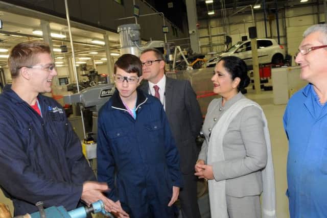 Dame Asha Khemka chats with students, Arturs Kurklis and Corey Tindall during a visit to the new Vision West Notts College's Engineering Innovation Centre on Monday.
