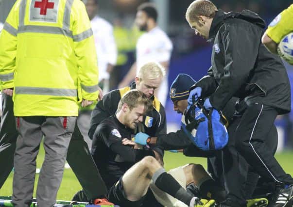 Doctors and Medics attend to Alex Fisher's shoulder injury -Pic by: Richard Parkes
