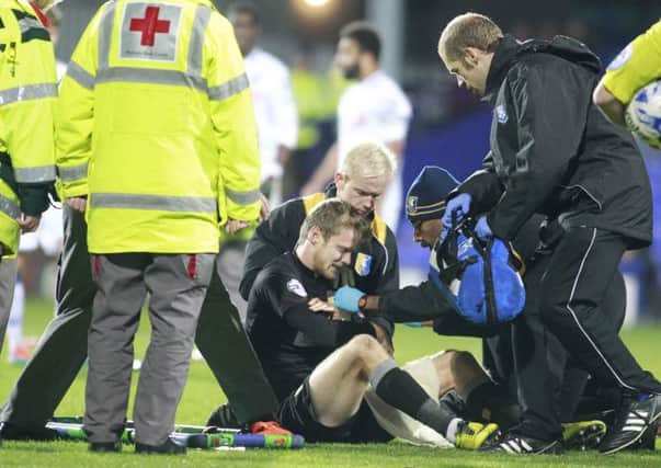Doctors and Medics attend to Alex Fisher's shoulder injury -Pic by: Richard Parkes