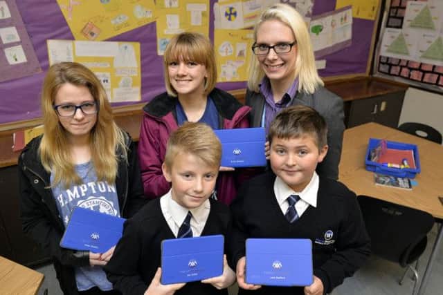 Pupils and staff at Manor Academy have been issued with Ipad's, pictured from left are Chloe Shelton, Emily Shelton, Principal Donna Trusler, Joe Collier and Leon Radford