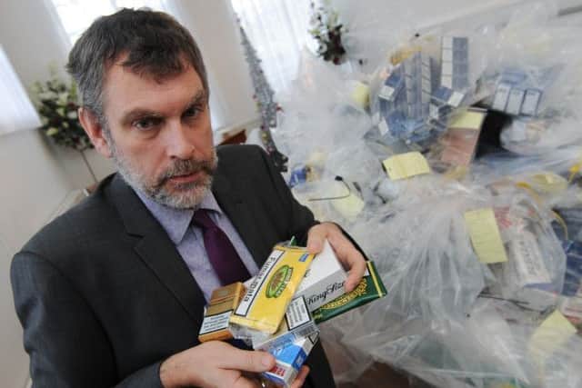 Notts Trading Standard have siezed around £50,000 of fake cigarettes. Pictured is Trading Standards Officer Paul Gretton with some of the counterfit products.