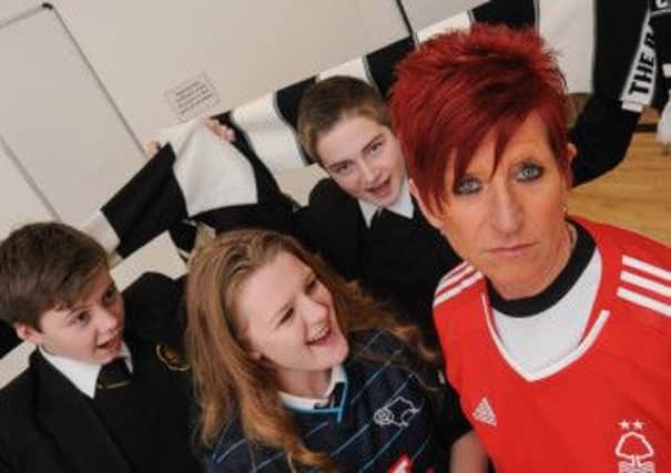 Derby County FC fan Lisa Howard, of Alfreton Grange Arts College, is being sponsored to wear a Nottingham Forest top and is pictured with students, left to right, Will Scott 13, Julia Day 15 and James Stevenson 14.