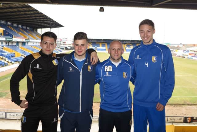 Adam Murray with his three young signings.