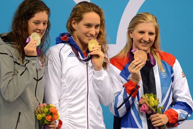 Camille Muffat (centre), celebrates her gold medal win with USA's silver winner Allison Schmitt (left) and Great Britain's bronze winner Rebecca Adlington (right) after the Women's 400m Freestyle final.