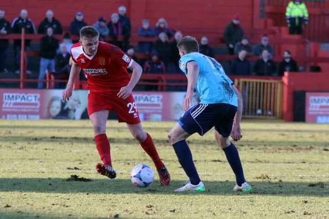 Alfretons new signing Aaron Bentley surges past Aldershots Jim Stevenson.