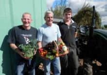 Rhubarb Farm volunteers display some of their organic produce.