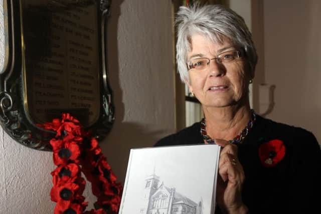LEST WE FORGET -- Lynne Weston with her book,'Soldiers Remembered 1914-1918'..