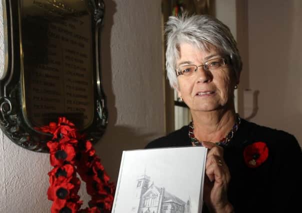 LEST WE FORGET -- Lynne Weston with her book,'Soldiers Remembered 1914-1918'..