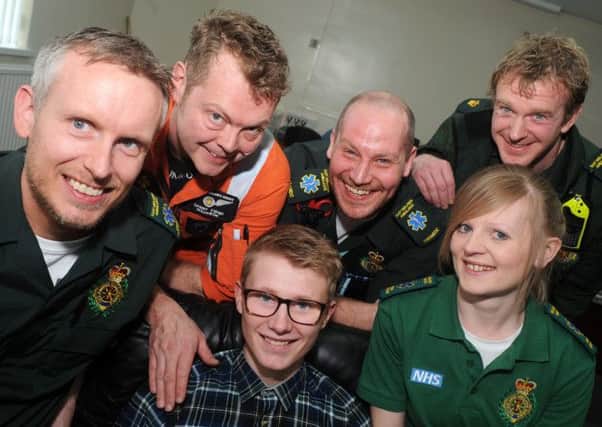 Kieren Brown with his saviours, from left, back row, Michael Ackroyd, Dan Evans, Gillian Caldwell, Kev Topliss and John Chippendale with Shaun Woodhouse and Amy-Jayne Parker front.