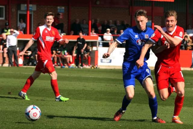 Alfretons Dan Bradley is fouled by Grimsbys Daniel Parslow.