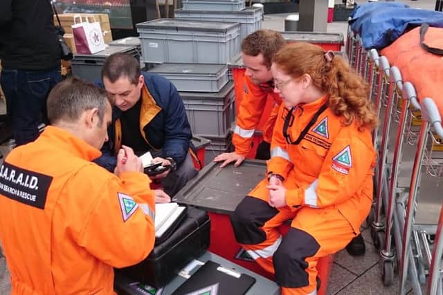 Volunteers from British charity Search and Rescue Assistance in Disasters (SARAID) check their equipment at Heathrow airport. Photo:PA