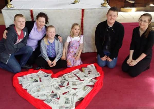 Some of the young people at St Mark's Church Mansfield  with 'Chad Prayers' placed at the altar table.