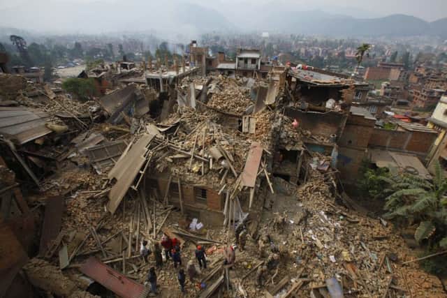 Rescue workers remove debris as they search for victims of earthquake in Bhaktapur near Kathmandu, Nepal. (AP Photo/Niranjan Shrestha)