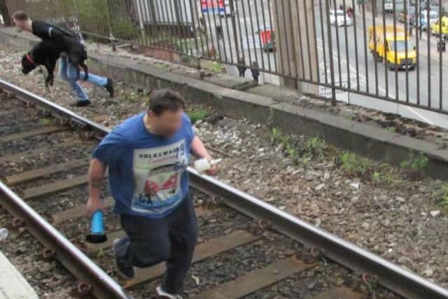 Dramatic moment Mickey Parkes jumped onto the tracks to save the dog