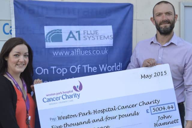 Ollerton businessman Hohn Hamnett has raised more than £7,500 for two local charities by climbing Mount Kilimanjaro.  L-R Sarah Cross (Weston Park) and John Hamnett (A1 Flues)
