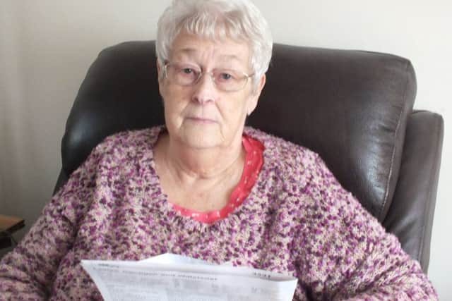 Marie Price holding the 'trust' document in her hands