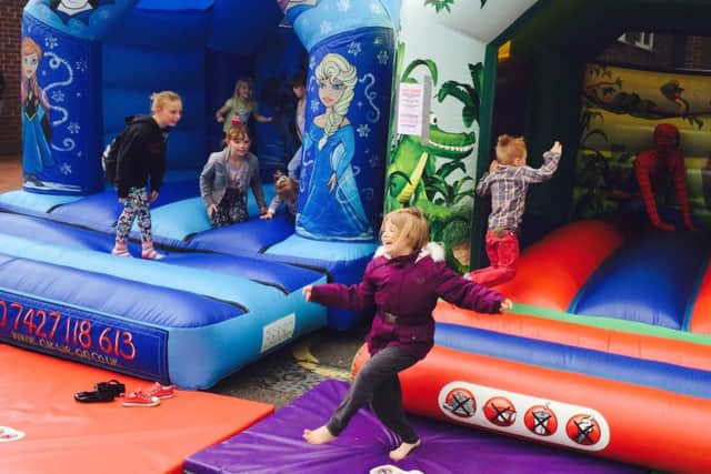 Young revellers enjoy the bouncy castles at a fundraiser for five year old Johua Smith at the Forest Town Arena. Joshua suffers from a rare brain condition and his family are fundraising to take him on what could be his last holiday.