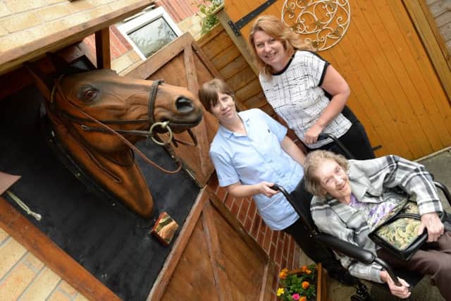A memorial of a horse peering out of its stables has been left at Ashfield Nursing Home in memory of former resident George Scotney. Resident Cynthia Nelson with Helen Shirley, care assistant and home manager Nicola Whitworth, right