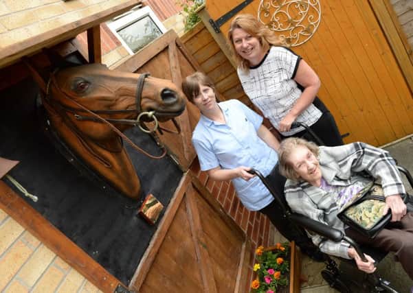 A memorial of a horse peering out of its stables has been left at Ashfield Nursing Home in memory of former resident George Scotney. Resident Cynthia Nelson with Helen Shirley, care assistant and home manager Nicola Whitworth, right