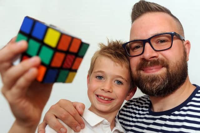 Rubik's Cube wizard, Harry Gilbert, 7, with dad Ian.