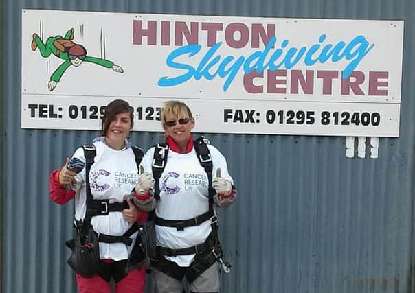 Diane Dennis and Jade Shetliffe took  to th eskies to raise more than £1,000 for Cancer Research UK when they plunged 14,000 feet in a skydive  at Hinton Skydiving Centre.
