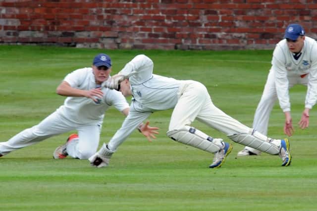 Kimberley wicket keeper, Harry Ratcliffe at full stretch to take the second Clifton wicket.