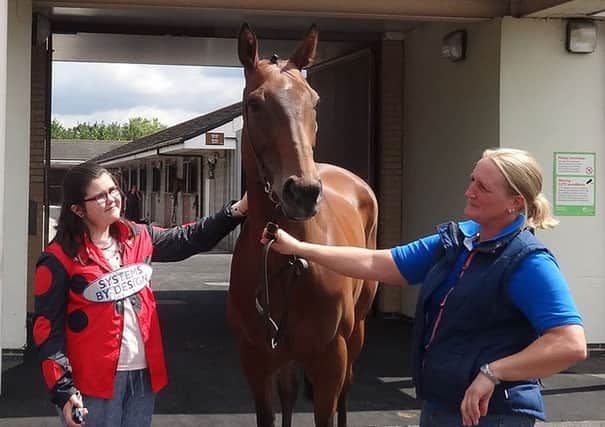 NICE TO MEET YOU -- 12-year-old Holgate pupil Alice Thompson meets one of the racehorses, Who's Shirl, who went on to win her race at Doncaster.