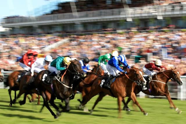 A GLORIOUS BLUR -- fast-paced action from the 2015 Qatar Goodwood Festival (PHOTO BY: John Walton/PA Wire).