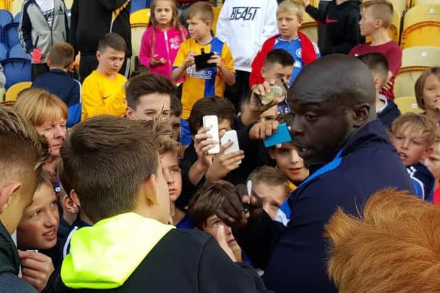 Ade Akinfenwa meets local youngsters at One Call Stadium after the game.
