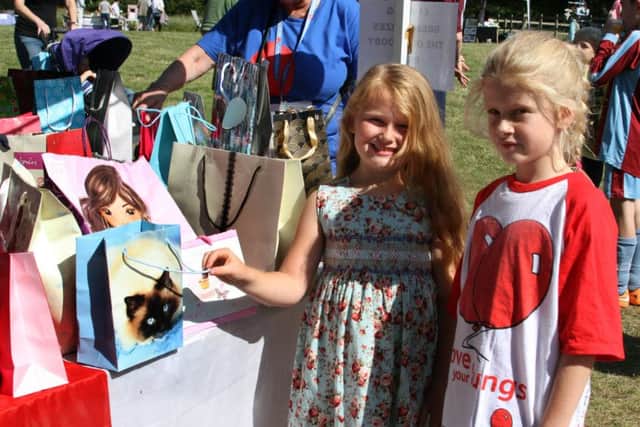 Jodie Atchinson-Watts and Rebecca Hollier have a go on the lucky bag stall run by Breath easy.