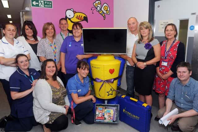 Staff on Ward 25 at Kings Mill Hospital, who were involved with the care of Kirkby teenager, Corah Slaney, are presented with a Starlight entertainment centre, for the ward, in her memory, by her parents Carl and Lisa, standing third and second right.