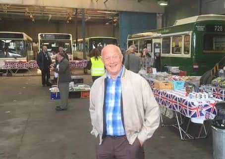 Volunteer Ken Widdison welcomes visitors to the new bus museum