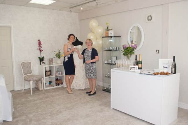 Katie Lyth opened House of Oliver Bridal Wear in Ilkeston after being shocked at the price of wedding dresses. She is pictured on the left alongside Erewash MP Maggie Throup, who cut the ribbon to open the new store.