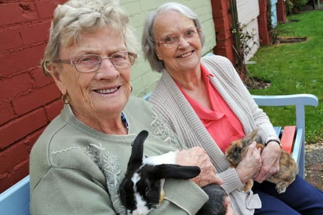 Newgate Lodge residents, Marjorie Hutchinson, left and Mary Jackson cuddle up the care home's newest members, Bubble and Squeak.