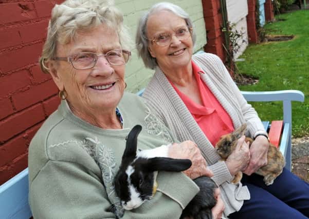 Newgate Lodge residents, Marjorie Hutchinson, left and Mary Jackson cuddle up the care home's newest members, Bubble and Squeak.