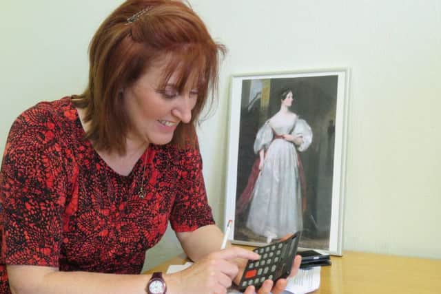 Leader of Ashfield District Council, Councillor Cheryl Butler, ponders over some fiendish maths puzzles using a calculator. Ada Lovelace's work inspired the invention of the calculator.
