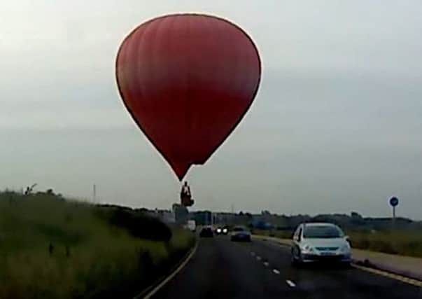 A hot air balloon gave drivers a scare as it landed on a field next to a Southport coastal road.