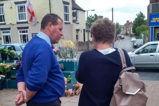 Sherwood MP Mark Spencer talks with a resident in Hucknall