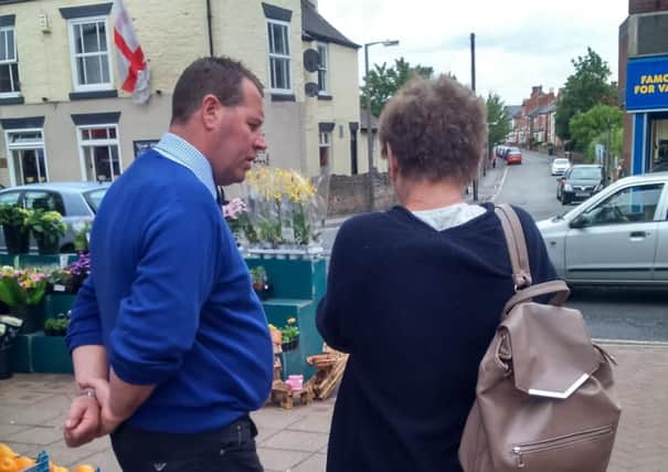 Sherwood MP Mark Spencer talks with a resident in Hucknall