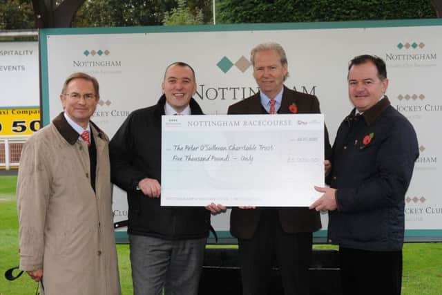 Geoffrey Hughes, Trustee of the Sir Peter OSullevan Charitable Trust, received a £5,000 cheque, half from the racecourse and half from the race-day sponsor 32Red.  From left: Peter Jensen (Racecourse Chairman); James Knox (Racecourse General Manager); Geoffrey Hughes; Edward Ware (32Red Chief Executive).